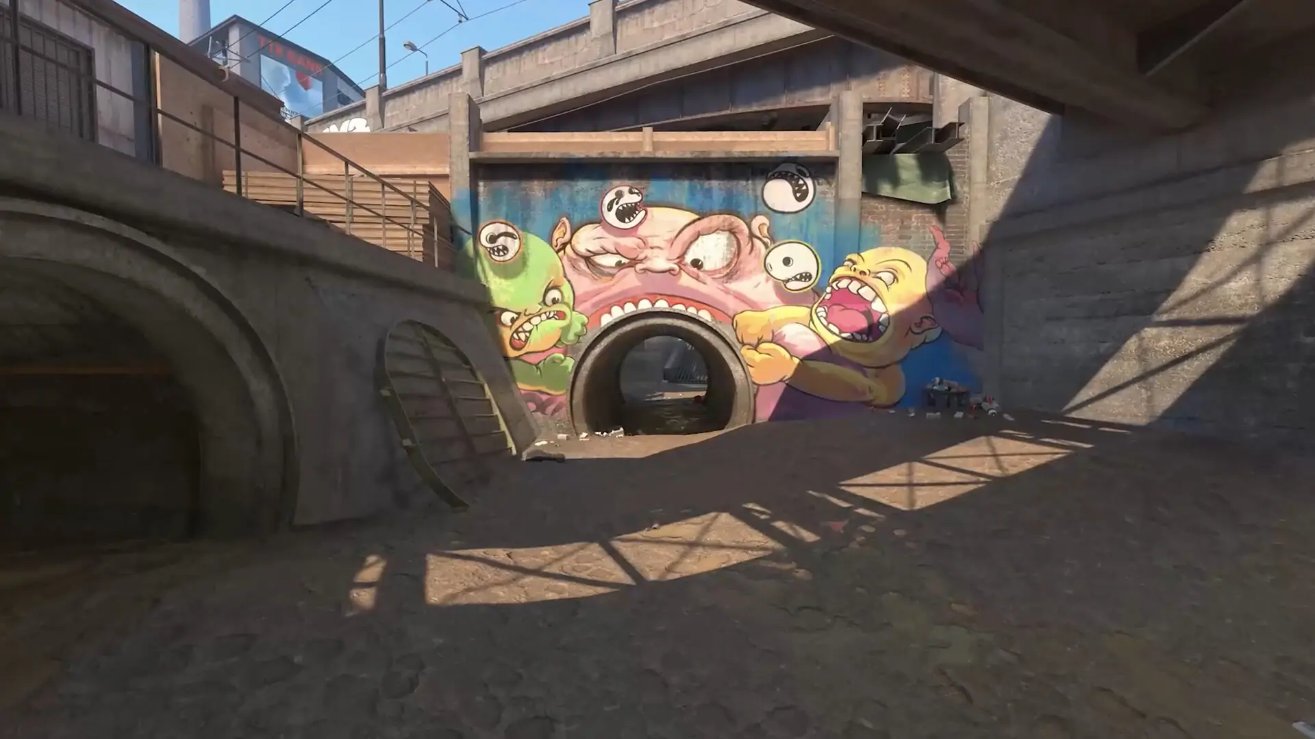 Pedaço do mapa de CS2 apresentando uma área com um túnel e graffitis.