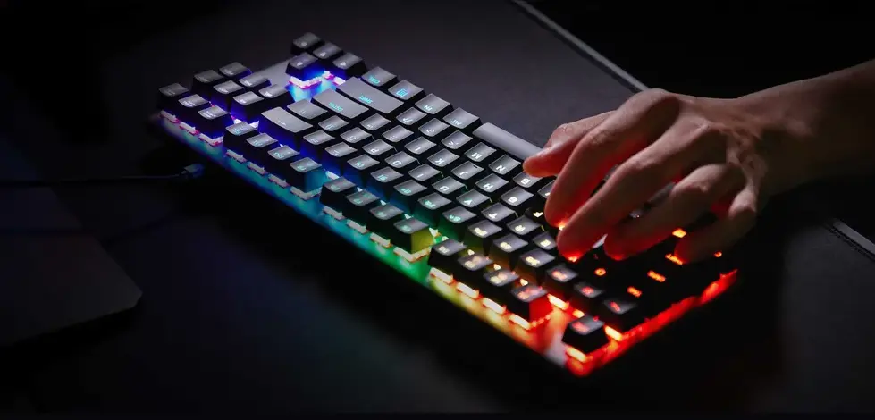 Teclado magnético com iluminação RGB sendo usado para digitação em computador.